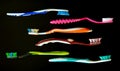 Used plastic toothbrushes on a black background. Ecology concept