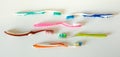 Used plastic toothbrushes on a white background