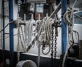 Used ropes and a chain hanging on the deck of a fishing boat Royalty Free Stock Photo