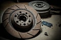 Used rusty brake discs lie on floor in auto workshop