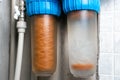 Used rusty double cartridge water filter. Plumbing system