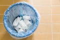 Used sanitary napkin pad wrapped and disposed in rubbish bin