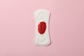 Used sanitary pad on pink background