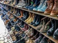 Used shoes in rows on local second hand shop. Royalty Free Stock Photo