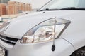 Used silver Toyota Passo with an engine of 1.3 liters front headlight with parking antenna view on the car snow parking after Royalty Free Stock Photo