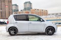 Used silver Toyota Passo with an engine of 1.3 liters side view on the car snow parking after preparing for sale Royalty Free Stock Photo