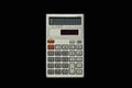 Used simple pocket calculator on isolated bkack background top view. Royalty Free Stock Photo