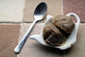 Used teabags on a teabag shaped plate, and a dirty spoon, on a kitchen windowsill Royalty Free Stock Photo