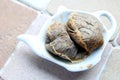 Used teabags on a teabag shaped plate on a kitchen windowsill Royalty Free Stock Photo