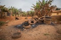 Used tires left in an illegal open landfill near houses in Africa, concept of pollution in Africa