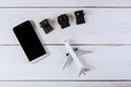 Used to connect to different electrical socket plug adapters outlets worldwide model airplane and smartphone on flat lay Royalty Free Stock Photo