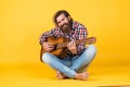 Used to look perfect. favorite tune. Portrait of happy bearded male playing guitar. a lonely musician. cheerful handsome Royalty Free Stock Photo