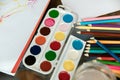 Used water-color paint-box, brush, pencils and pastels on wooden with paper Royalty Free Stock Photo