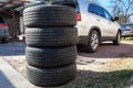 Used wheels with summer tires for suv car stacking on earth, seasonal tyre change