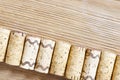 Used wine corks close up lying in a diagonal row on a wooden surface