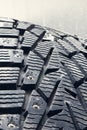 Used winter studded tire for car.Studded wheel for car close-up Royalty Free Stock Photo