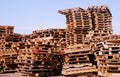 Used wooden pallets stacked under open sky