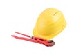 Used Yellow safety helmet with red adjustable pliers isolated on white background. Clipping path saved. Protection helmet, constru Royalty Free Stock Photo