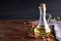 Useful Almond oil in glass bottles. Dark wooden background Copyspace