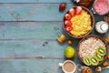 A useful breakfast with cereals and milk on a blue-green rustic background. Corn flakes, muesli, strawberries, kiwi, nuts, coffee, Royalty Free Stock Photo