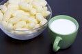 Useful breakfast. Corn sticks in a container and a mug of milk. On a dark background. Royalty Free Stock Photo