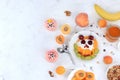 Useful breakfast with ingredients, flat lay, fruit salad with granola, apricots, bananas, honey and peaches on a bright table. The Royalty Free Stock Photo