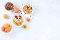 Useful breakfast with ingredients, place for text, fruit salad with granola, apricots, bananas, honey and peaches on a bright Royalty Free Stock Photo