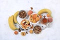 Useful breakfast with ingredients, place for text, fruit salad with granola, apricots, bananas, honey and peaches on a bright Royalty Free Stock Photo