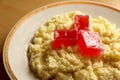 Useful breakfast. wheat porridge with marmalade. golden gruel from millet with pieces of fresh fruit jelly.