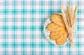 Useful cereal biscuits and wheat ears on a checkered tablecloth. Home breakfast.