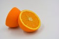 Useful and delicious fruits for human health. Orange oranges cut into two halves. Juicy fresh fades of orange with bones. Royalty Free Stock Photo