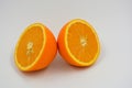 Useful and delicious fruits for human health. Orange oranges cut into two halves. Juicy fresh fades of orange with bones. Royalty Free Stock Photo