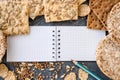 Useful dietary, crispbread, flakes, buckwheat, cookies with sunflower on a textured background. A sheet paper with pencil  to Royalty Free Stock Photo