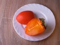 Persimmon fruit, close ripe fruits on a plate