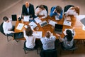 Useful info, news. Aerial view of young multiethnic people talking, working with colleagues, co-workers at office Royalty Free Stock Photo