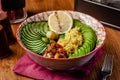 Useful Italian vegan food. Vegetarian bowl for breakfast of porridge couscous, avocado, cucumber, Brussels sprouts and vegetable