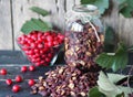 Useful properties of hawthorn berries. Fresh and dried hawthorn on a wooden background.Alternative traditional medicine