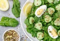 Useful spinach salad, cucumbers, eggs and seeds pumpkin, flax and sunflower Royalty Free Stock Photo