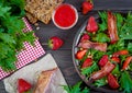 Useful strawberry salad with arugula, nuts and bacon, berry sauce