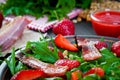 Useful strawberry salad with arugula, nuts and bacon, berry sauce