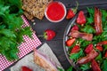 Useful strawberry salad with arugula, nuts and bacon, berry sauce