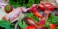 Useful strawberry salad with arugula, nuts and bacon, berry sauce