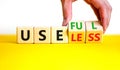 Useful or useless symbol. Concept words Useful or Useless on wooden cubes. Businessman hand. Beautiful yellow table white