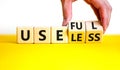 Useful or useless symbol. Concept words Useful or Useless on wooden cubes. Businessman hand. Beautiful yellow table white