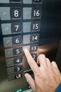 User finger reading Braille on elevator panel