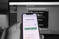User holding SmartPhone, while doing email login to ChatGPT service. Developed by OpenAI.