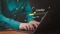 User man using a laptop computer for download and update software and waiting to loading digital file data form website Royalty Free Stock Photo