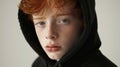 User redhead boy wearing black hoodie. Photograph by Loretta Lux,