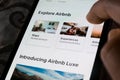 A user using the Airbnb app on a smartphone - exploring travel destinations