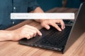 User working with laptop computer on table in office. Search engine optimization the internet with search bar.